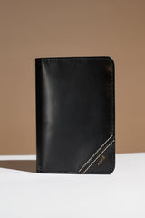 Mens leather bifold passport wallet in black colour with white contrast stitching and metal brand logo by JULKE