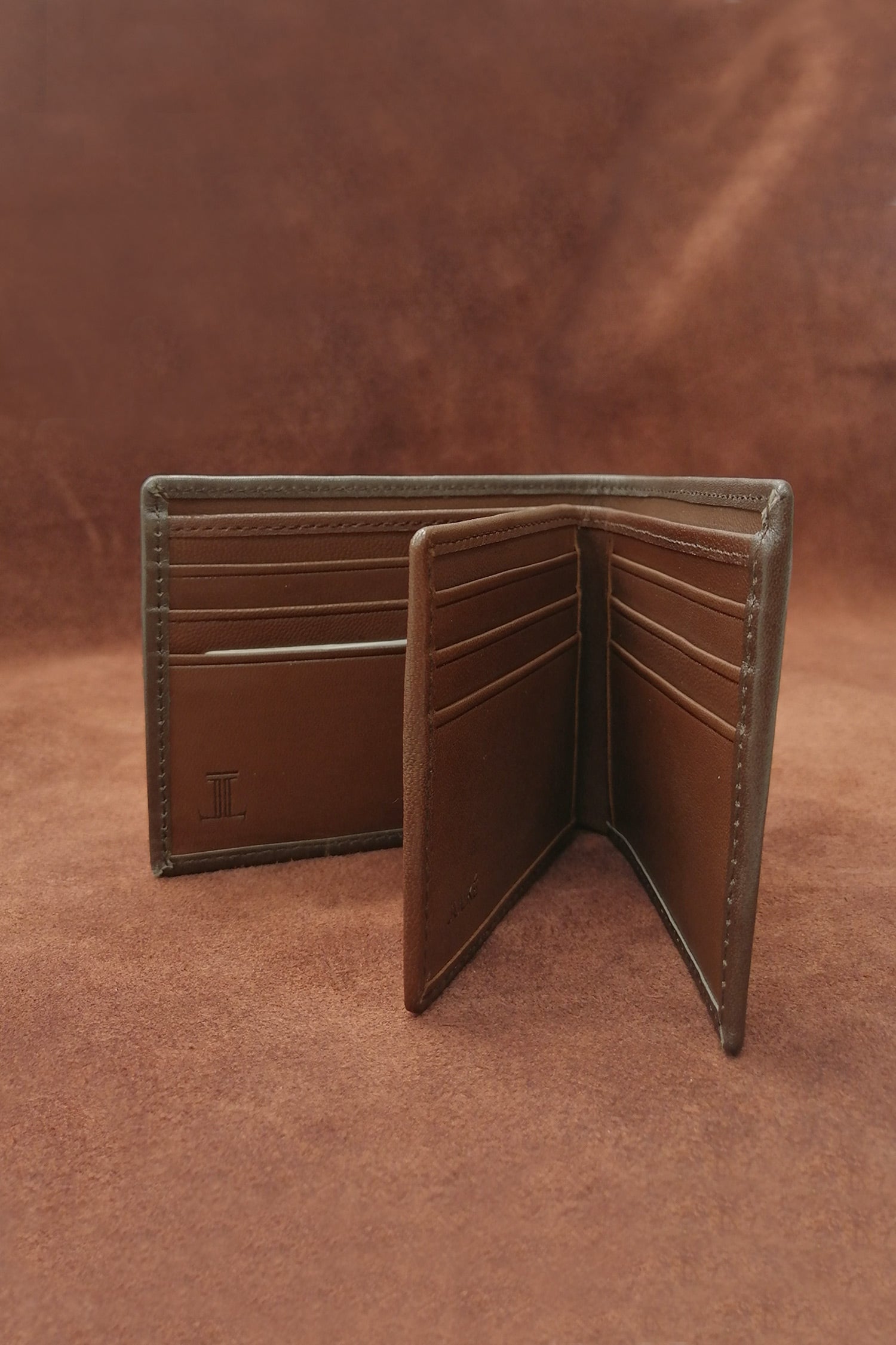 Mens leather bifold wallet in dark brown colour with contrast stitching and gold metallic brand trims by JULKE