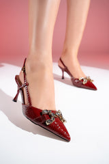 Women's sling back pointed toe heels in dark red colour with glossy dragon scale texture and rhinestone horse-bit buckle by JULKE. 