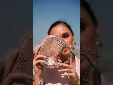 Women's leather mini halfmoon bag in metallic pink colour with 3d reptile texture unique clip-on handle and matching slingback heels by JULKE.
