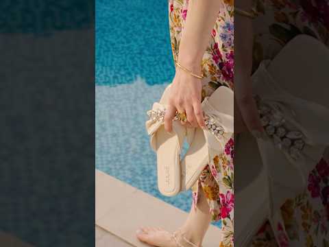 Womens flat slides in light blue & beige colours with asymmetric bow strap and floral diamante chain ornament by JULKE. 