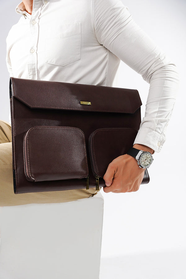 Leather laptop sleeve in dark brown colour with front pockets by JULKE