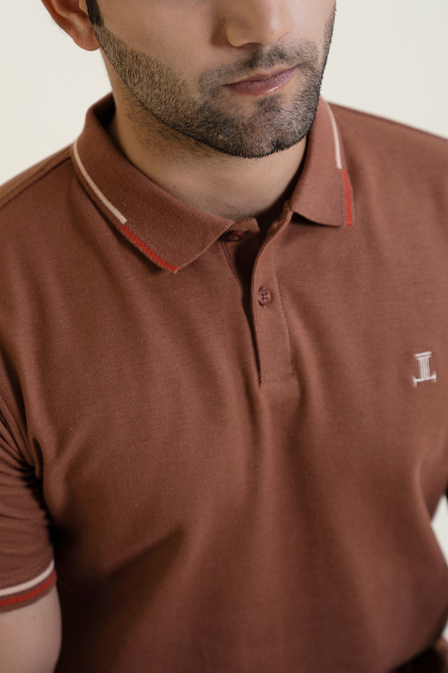 Mens polos shirt in brown colour with red and wwhite tipped sleeves and collar by JULKE. 